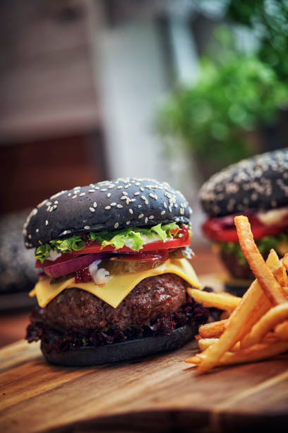 istock Black Burger Buns with Beef Pattie, Cheese, Tomato and Lettuce 1054612488
