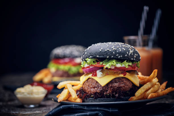 istock Black Burger Buns with Beef Pattie, Cheese, Tomato and Lettuce 1054612500