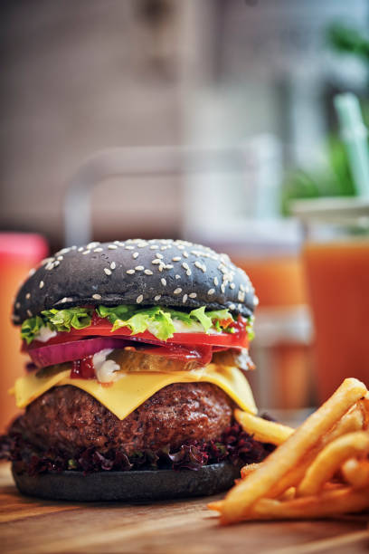 istock Black Burger Buns with Beef Pattie, Cheese, Tomato and Lettuce 1054612502