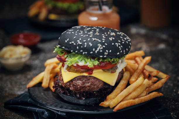 istock Black Burger Buns with Beef Pattie, Cheese, Tomato and Lettuce 1054612506