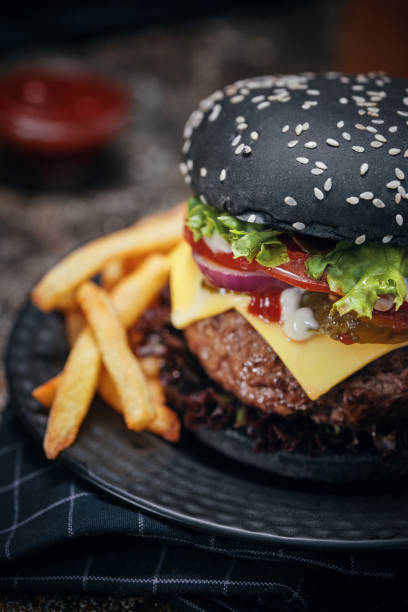 istock Black Burger Buns with Beef Pattie, Cheese, Tomato and Lettuce 1054612510