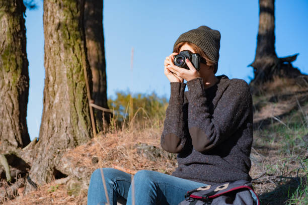 istock Taking a photo with an old analog camera in the forest 1054613348