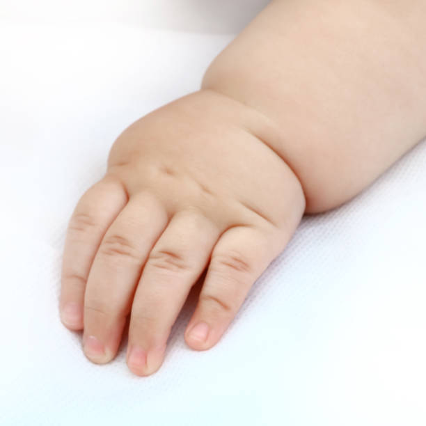 istock baby boy's hand on white background 1054614870