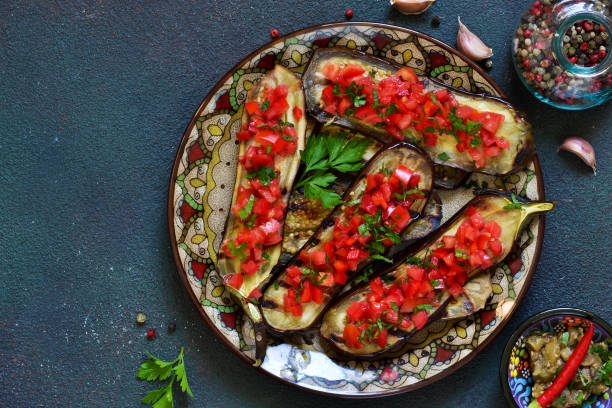 istock Spicy baked eggplant grilled with tomatoes and peppers. 1054618300