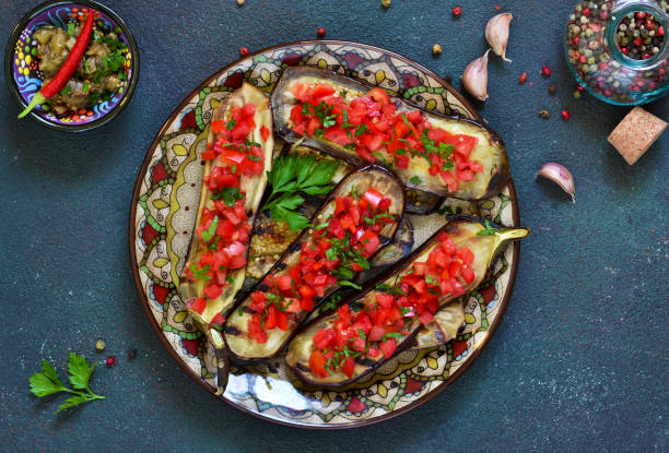 istock Spicy baked eggplant grilled with tomatoes and peppers. 1054618320