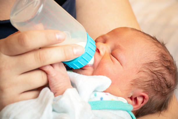 istock Newborn gets milk from the bottle 1054618706
