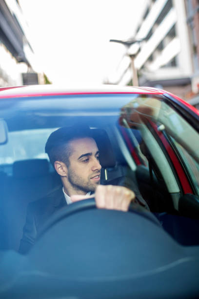 istock Businessman driving a car 1054618710