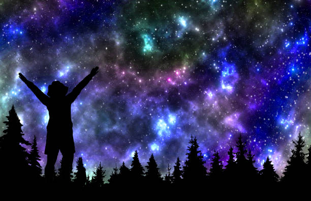 istock Woman watching the stars in night sky above the pine forest 1054623708