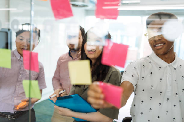 istock Diverse business people working in team with stick notes in office 1054626352