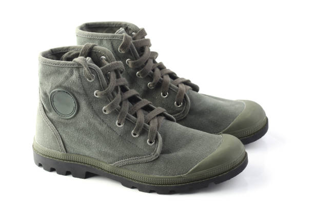 istock Green military style sneakers isolated on white 1054626480