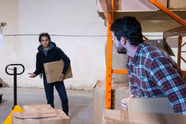 istock A warehouse worker risking hitting his head on some shelving. 1054630510