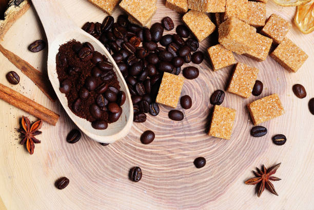 istock Fried coffee beans in a spoon and brown cane sugar 1054633282