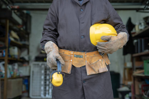 istock Mechanic in the locksmith workshop. An employee while working at the workplace. A locksmith workshop in the background. 1054640594