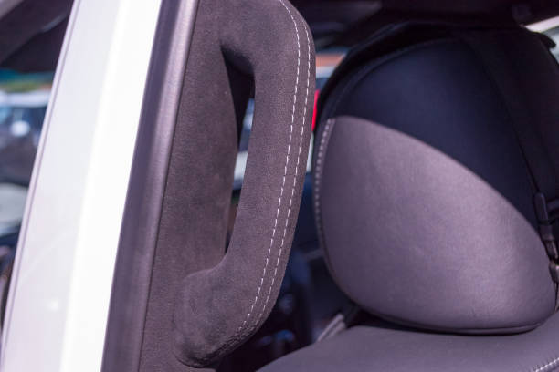 istock A close-up view of a black plastic handle on the ceiling in a car in a passenger seat pulled by a black soft leather cloth in the workshop of a tuning studio 1054640748