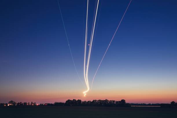 istock Light trails of airplane during landing 1054647802