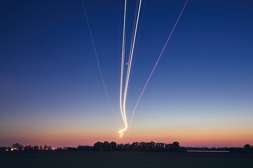 Light trails of airplane during landing at airport after sunset. Prague, Czech Republic.