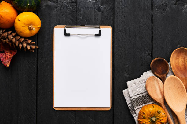 istock Autumn vegetables cooking preparation background with cardboard clipboard for menu or recipes 1054649716