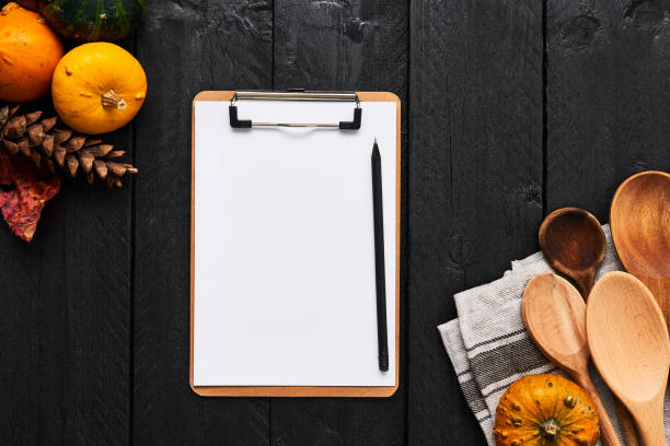 istock Autumn vegetables cooking preparation background with cardboard clipboard for menu or recipes 1054649732