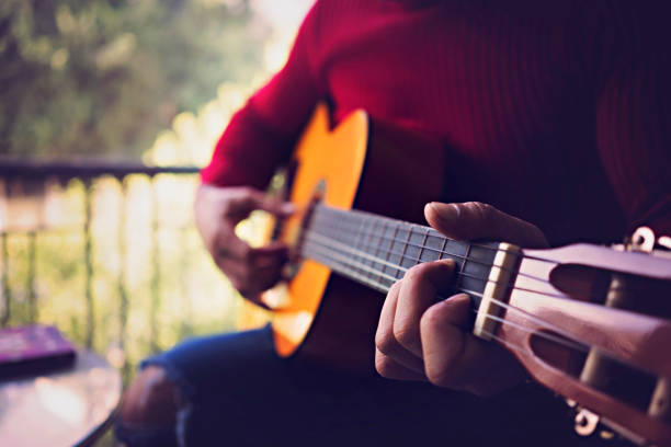 istock Young man playing the guitar in a cafe. 1054653432