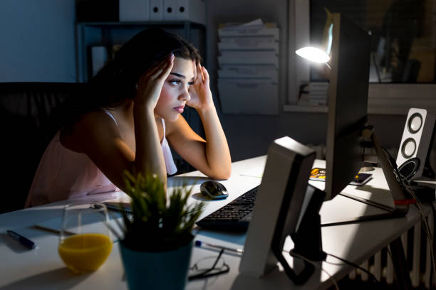 istock Female entrepreneur working from home late at night 1054653846