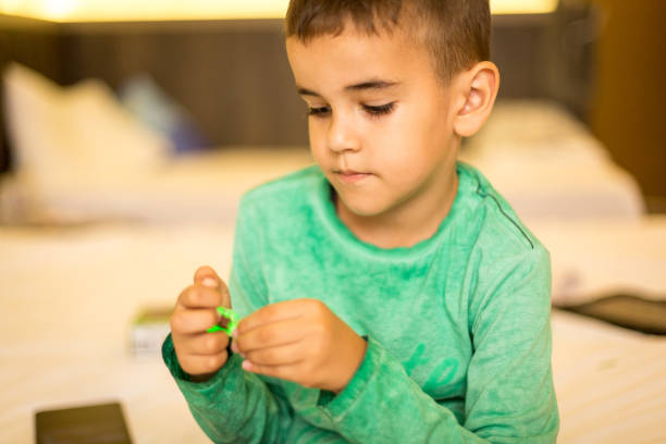 istock Little boy playing with toy blocks 1054655814