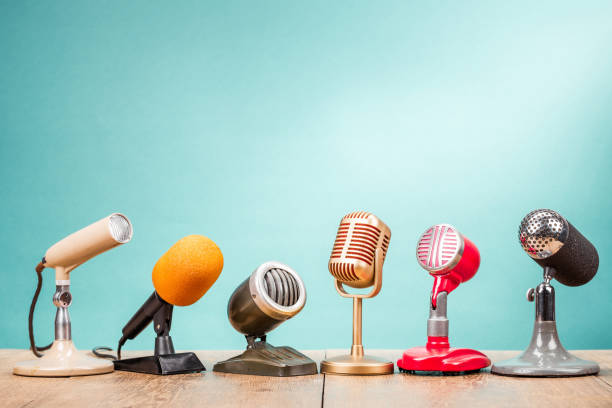 Retro old microphones for press conference or interview on table front gradient aquamarine background. Vintage old style filtered photo Retro old microphones for press conference or interview on table front gradient aquamarine background. Vintage old style filtered photo commentator photos stock pictures, royalty-free photos & images