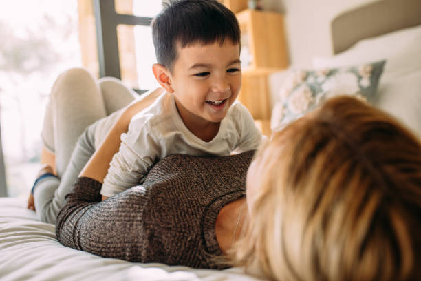 istock Mother and son having a fun time at home 1054661080