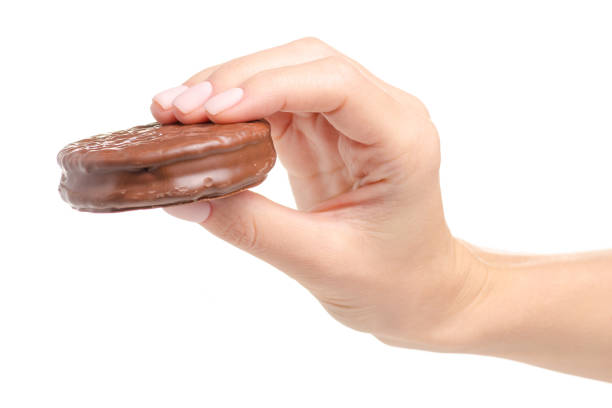 istock Chocolate sandwich cookie in hand 1054662634