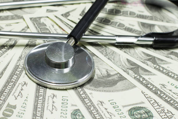 istock Stethoscope on money background - medical concept 1054664688