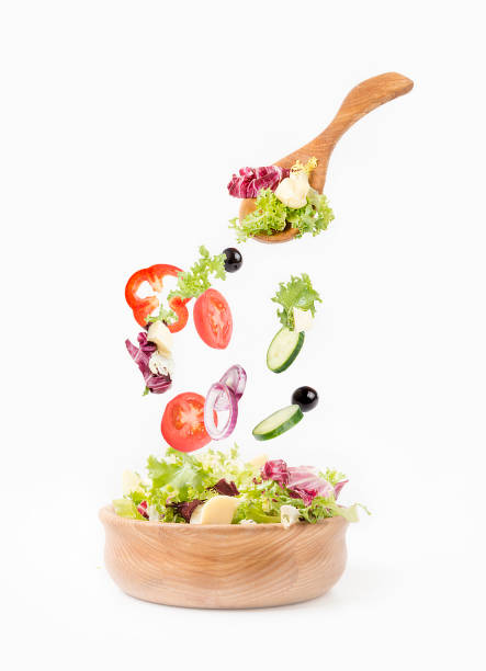 Wooden dishes with salad on a white background.