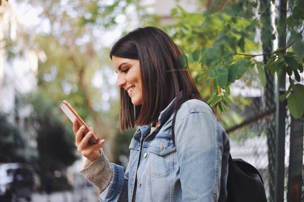 istock Young woman looking at her smart phone 1054669234