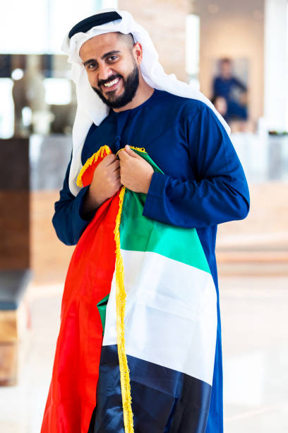 istock Proud Emirati Man with UAE flag 1054673508