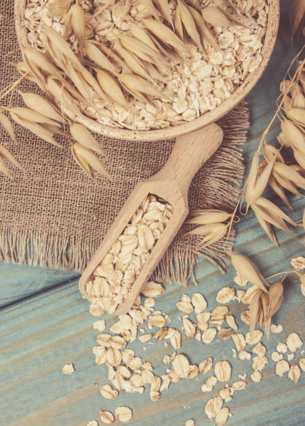 istock Oat flakes in a bowl on the blue board. 1054674882