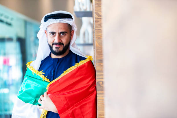 istock Proud Emirati Man with UAE flag 1054676998