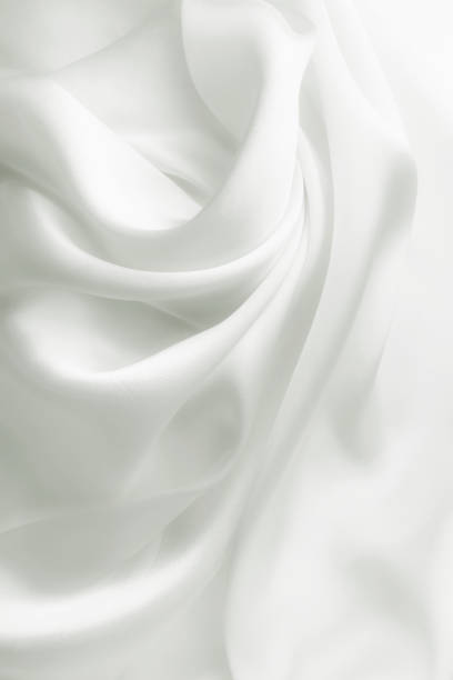 istock Elegant white soft silk with waves, texture background 1054678602