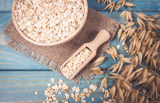 istock Oat flakes in a bowl on the blue board. 1054678664