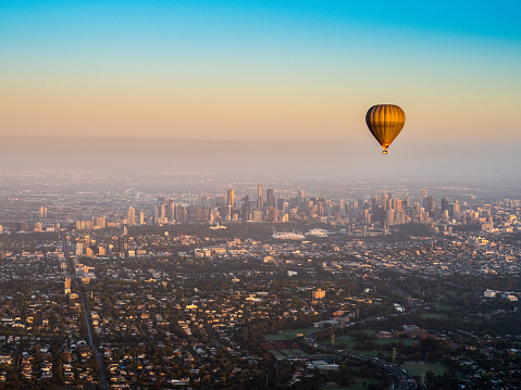 Australia: Hot Air Balloon above Melbourne city skyline with clear and calm sunrise