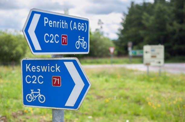 Signpost on C2C Route 71 of the UK's National Cycle Network from Whitehaven to Tynemouth CUMBRIA, ENGLAND - JUNE 14, 2016 - Signpost on C2C Route 71 of the UK's National Cycle Network from Whitehaven to Tynemouth keswick photos stock pictures, royalty-free photos & images