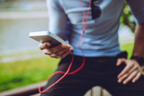 istock man listening to music by the river 1054685896