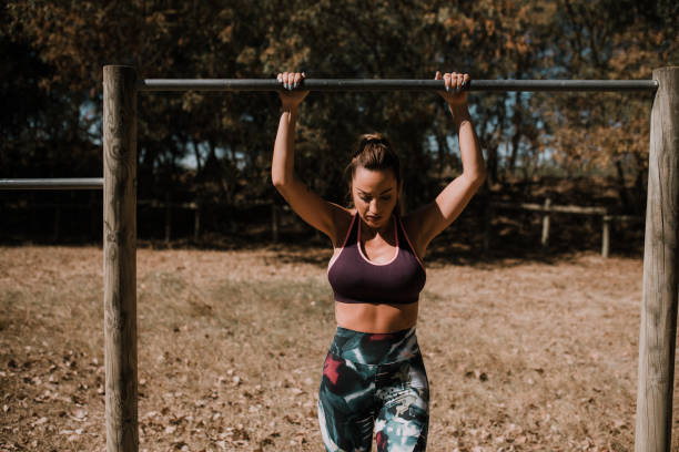 istock Young woman stretching at a gymnastics bar 1054686088