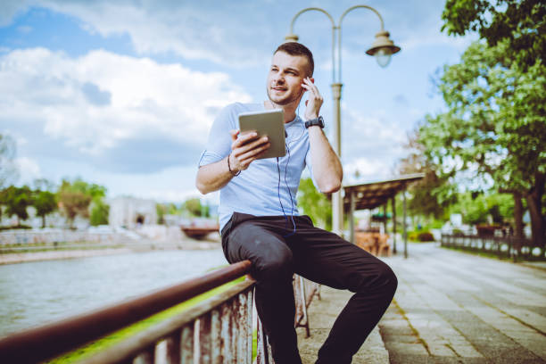 istock man listening to music by the river 1054689464
