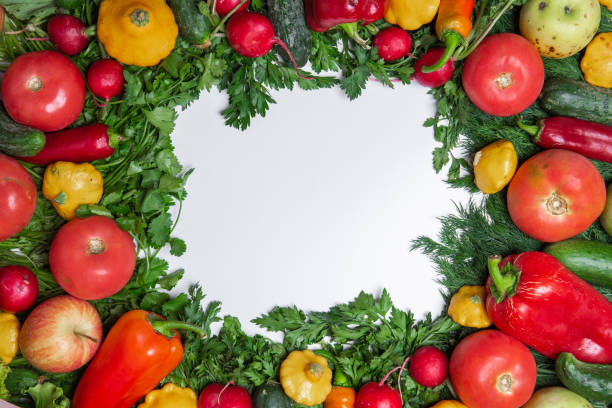 istock colorful frame made of assorted vegetables and herbs on white background, healthy background, copy space for text in the middle, top view 1054692584
