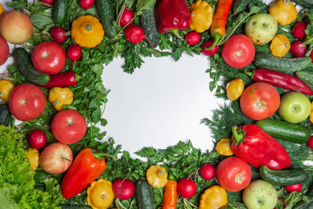 istock colorful frame made of assorted vegetables and herbs on white background, healthy background, copy space for text in the middle, top view 1054692768