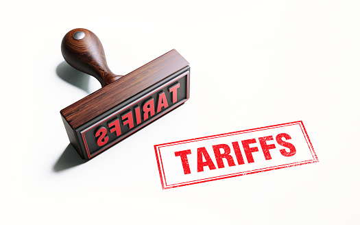 Wooden tariffs stamp on white background. Horizontal composition with copy space.