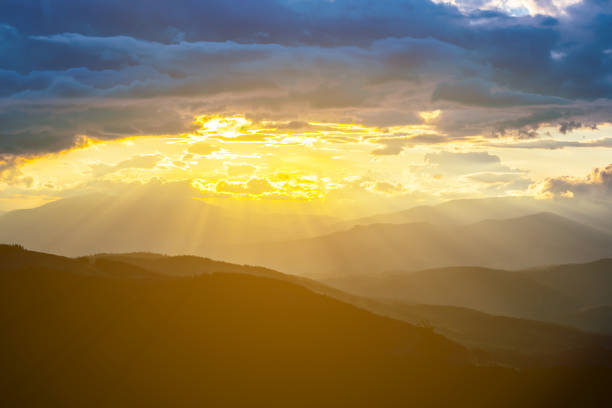 istock dramatic sunset over the misty mountain valley 1054705042
