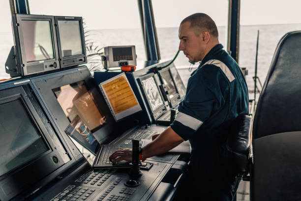 istock Marine navigational officer is using laptop or notebook at sea 1054709452