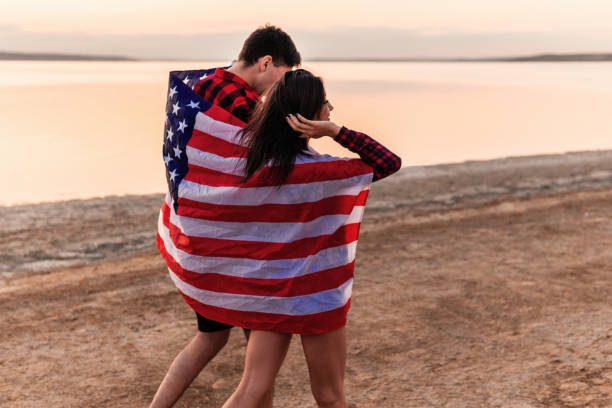 istock oung couple on the beach walking together 1054713370