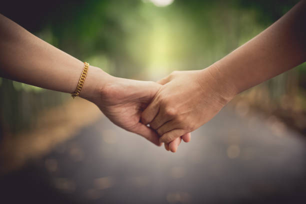 istock closeup women's hands holding together 1054713468