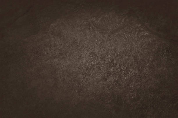 istock Dark brown slate texture in natural pattern with high resolution for background and design art work. Brown stone wall. 1054722518