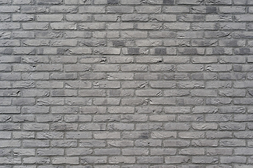 Dark gray stone wall, background, texture. Old dark gray brick wall texture background